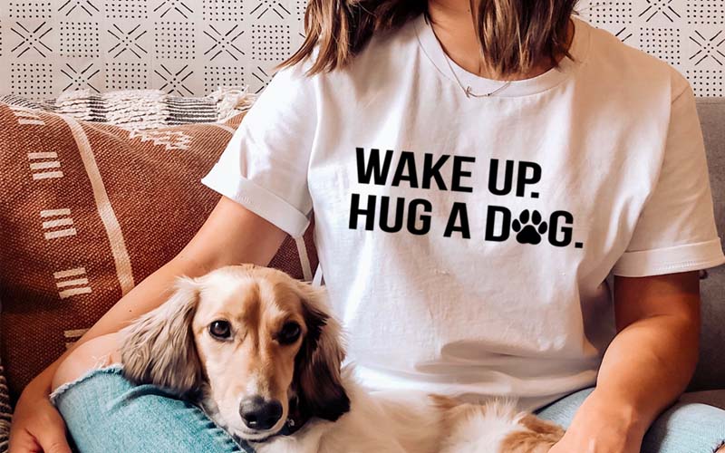 https://cdn2.inspireuplift.com/wp-content/uploads/2022/04/Wake-Up-Hug-A-Dog-Tee.jpg