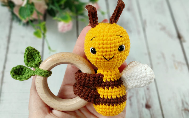 Bee toy with a wooden baby rattle ring